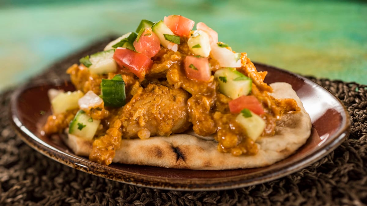 Korma Chicken with Cucumber Tomato Salad, Almonds, Cashews, and Warm Naan Bread 