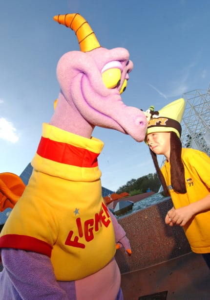 FIGMENT APPEARS AT EPCOT | The Main Street Mouse Purple Power Figment the Playful Purple Dragon Who Has Captured Millions of Hearts at Epcot Since He First Debuted in 1983 Has Begun Making Meet and greet Appearances Near the Theme Park's Imagination! pavilion and his attraction, Journey Into Imagination with Figment. Here, Zachary Winnell from Coloma, Mich. gets up-close and personal with the attraction's mischevious star. Epcot is one of four theme parks at Walt Disney World Resort in Lake Buena Vista, Fla. (photo: Diana Zalucky)