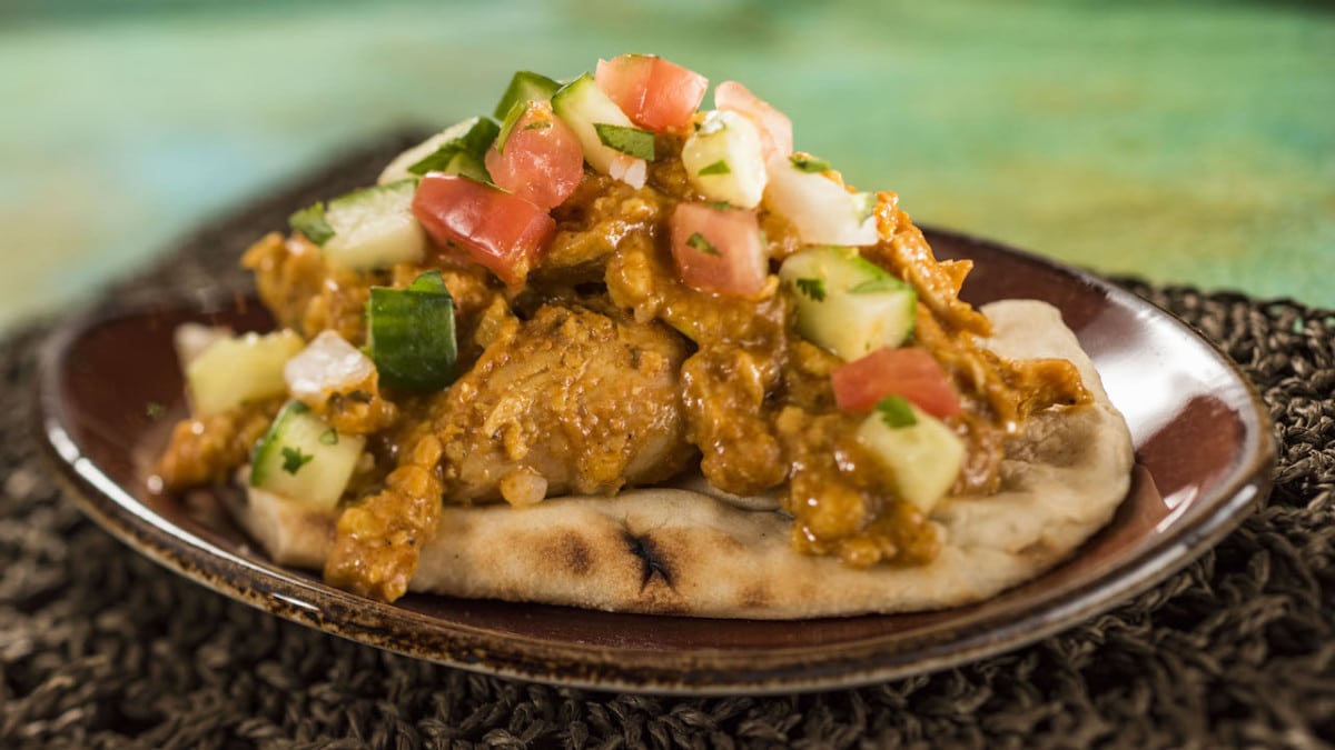 Korma Chicken with Cucumber Tomato Salad, Almonds, Cashews, and Warm Naan Bread 