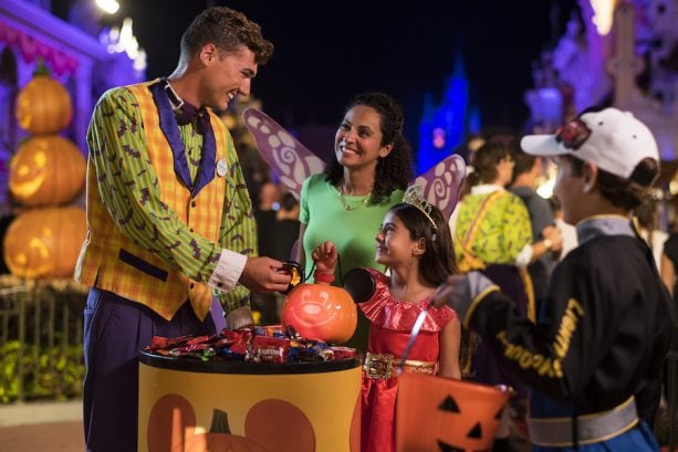 Cast Member Giving Out Candy at Mickey’s Not-So-Scary Halloween Party at Magic Kingdom Park
