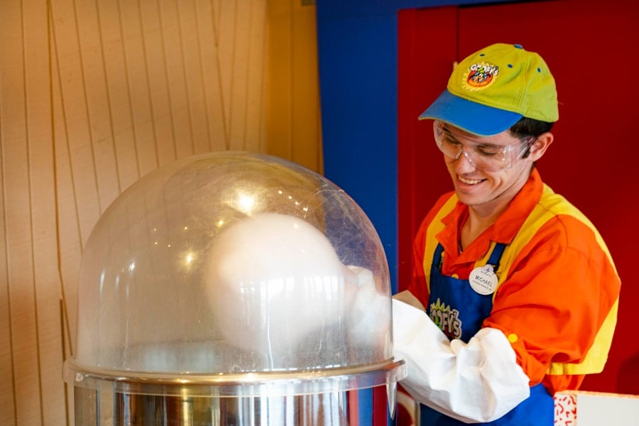 Cast member makes cotton candy at Goofy’s Candy Co. at Disney Springs