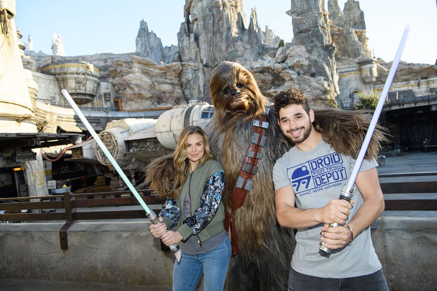 "Dancing with the stars" contestant “The Bachelorette” Hannah Brown, and her partner, professional dancer Alan Bersten, pose with Chewbacca in Star Wars: Galaxy’s Edge