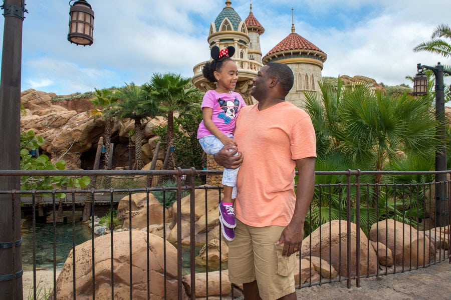 Disney PhotoPass photo opportunity in front of Prince Eric's Castle in Fantasyland at Magic Kingdom Park