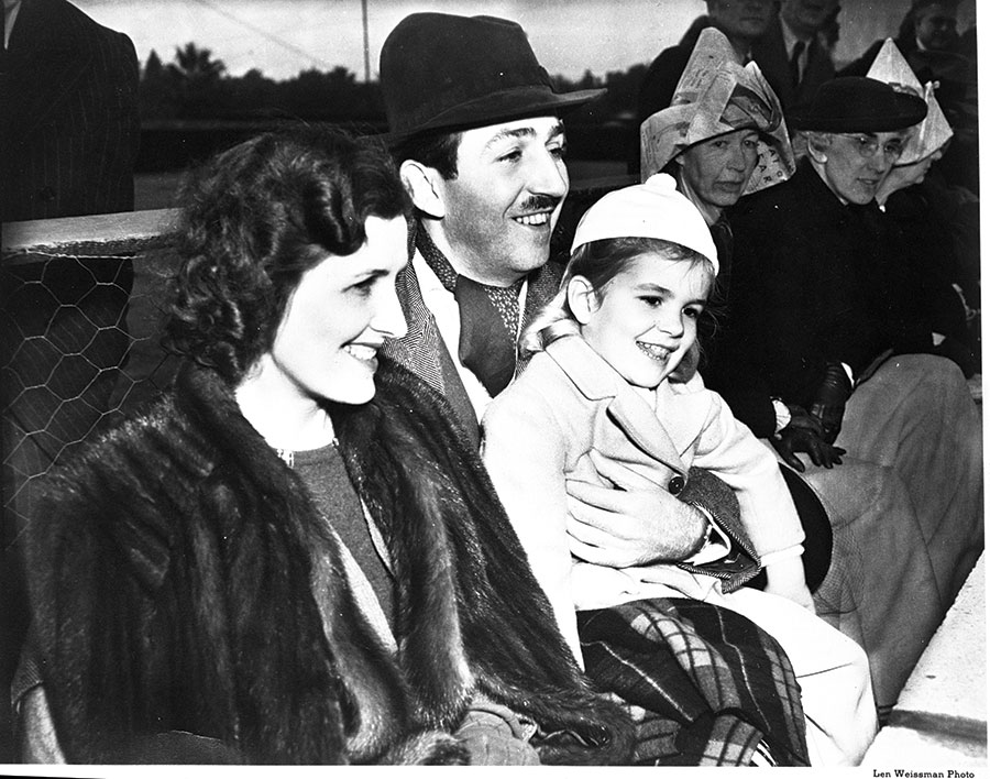 Lillian, Walt, and Diane Disney watch the Rose Parade in 1939