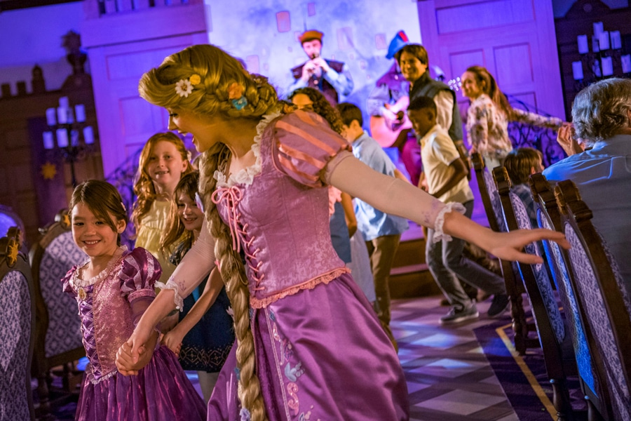 Rapunzel dances with guests in Rapunzel's Royal Table aboard the Disney Magic