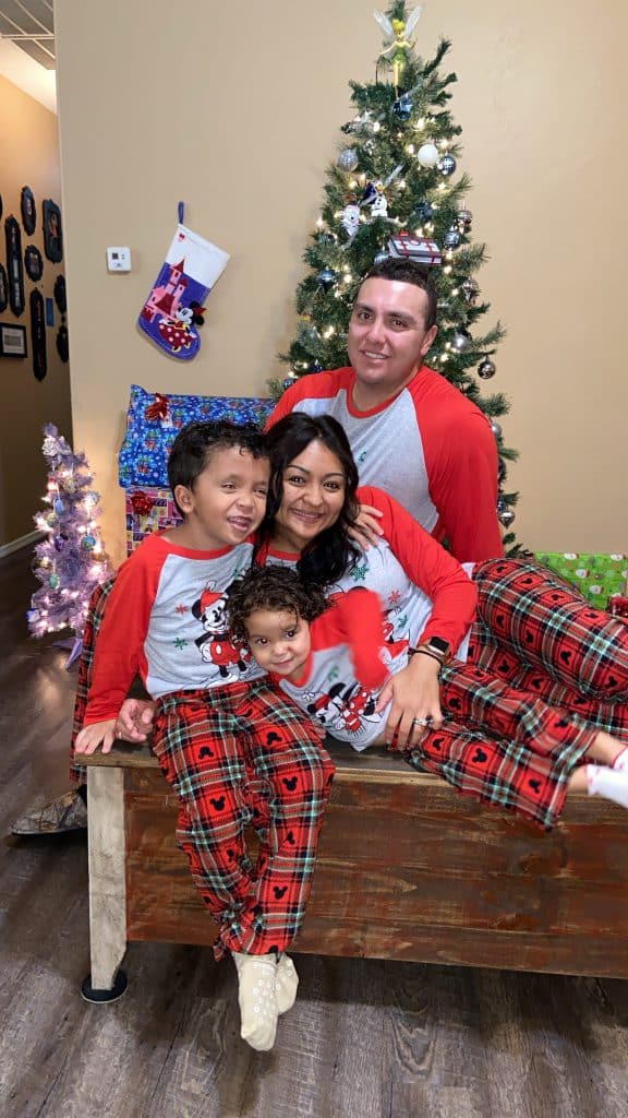 Family in matching Disney Christmas pajamas