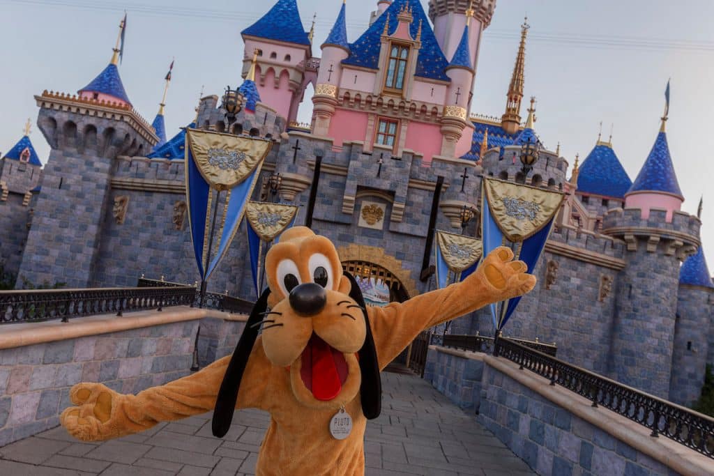Pluto in front of Sleeping Beauty Castle at Disneyland Resort