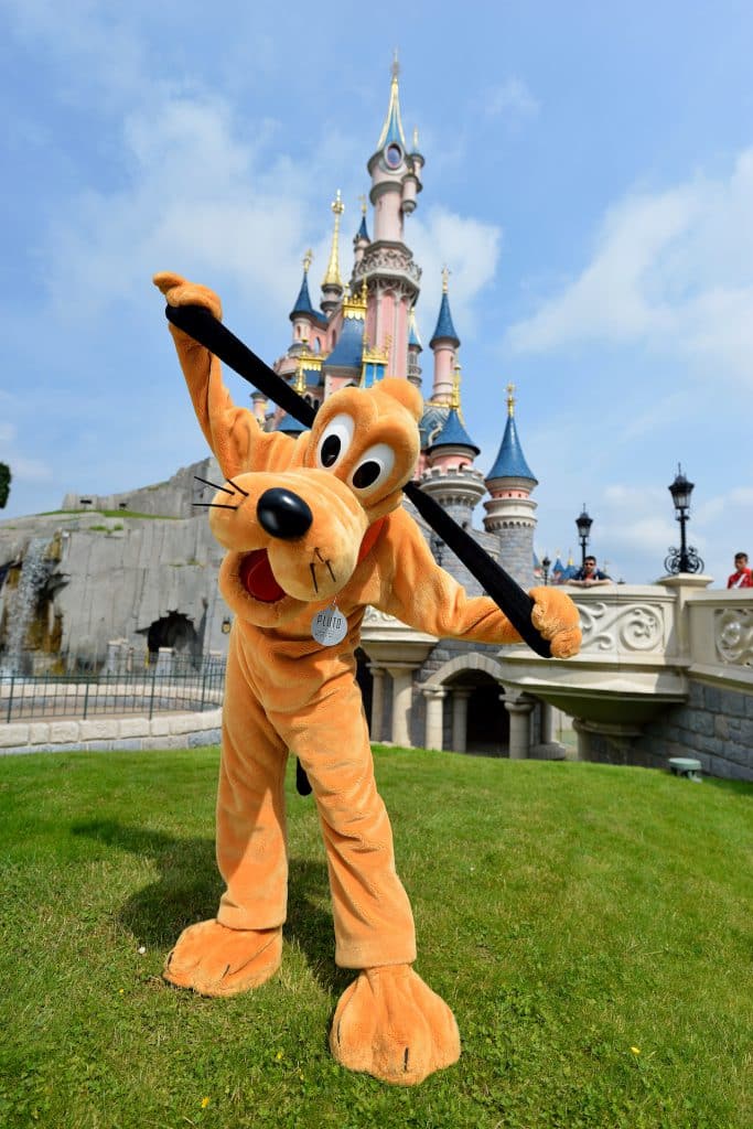 Pluto in front of Sleeping Beauty Castle at Disneyland Paris