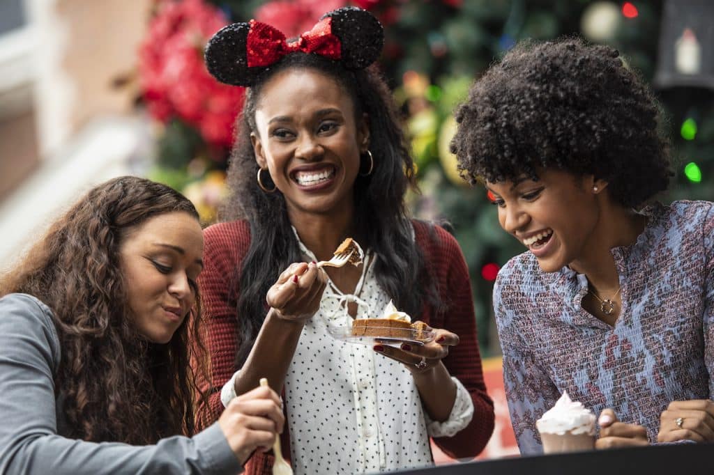 Friends eating at EPCOT during the holidays