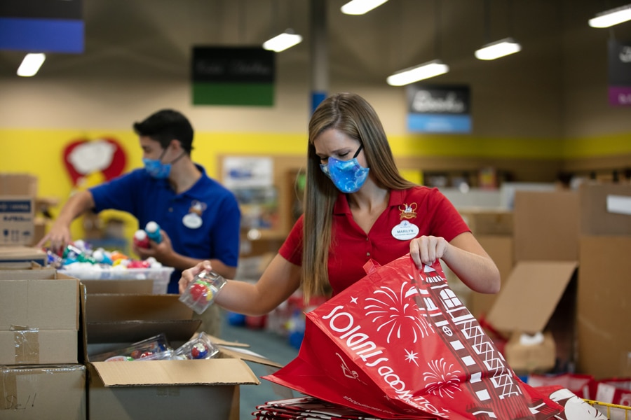 | The Main Street Mouse Walt Disney World Ambassadors Marilyn West and Stephen Lim Packing Supplies at a Gift for Teaching