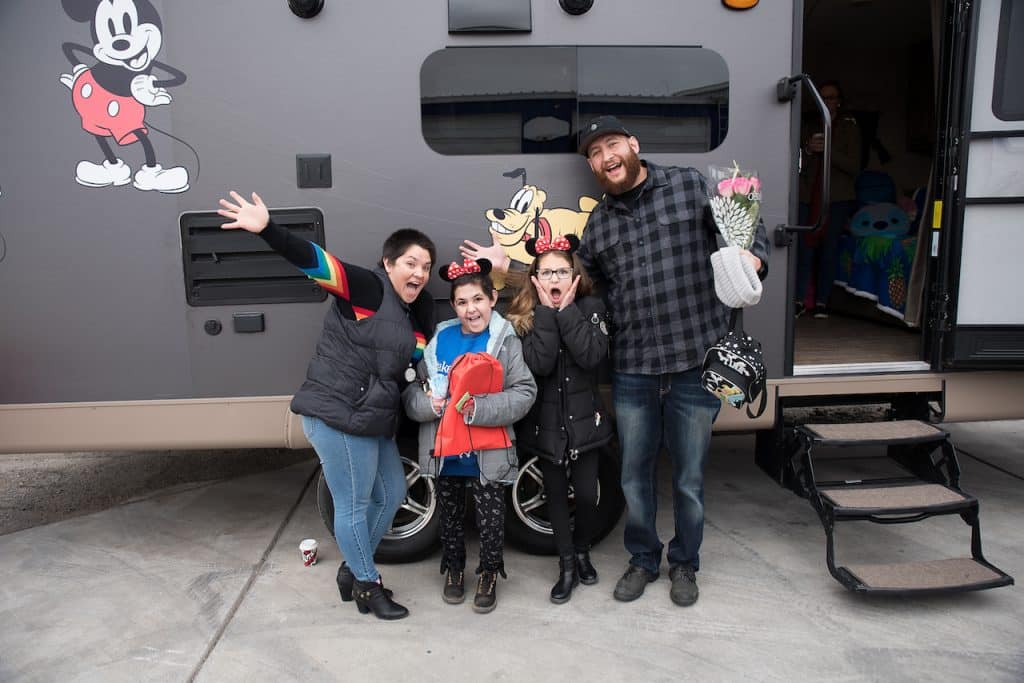 Wish kid Tali and her family in front of her Disney-themed RV