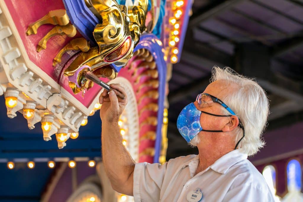 Cast member updating an attraction at Magic Kingdom Park