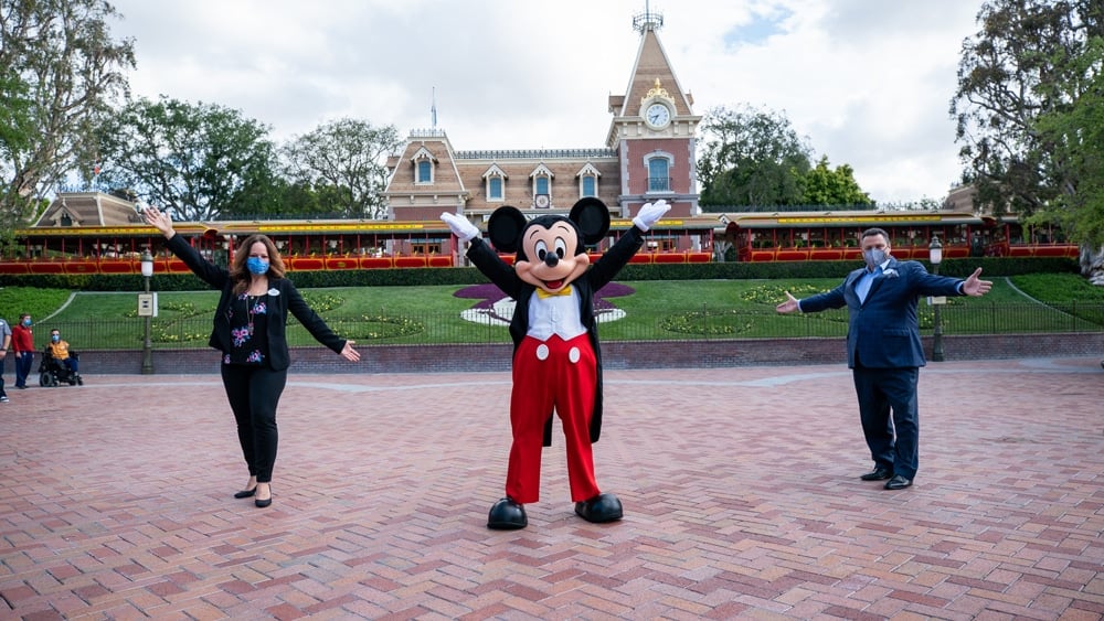 Mickey Mouse and two cast members at Disneyland park