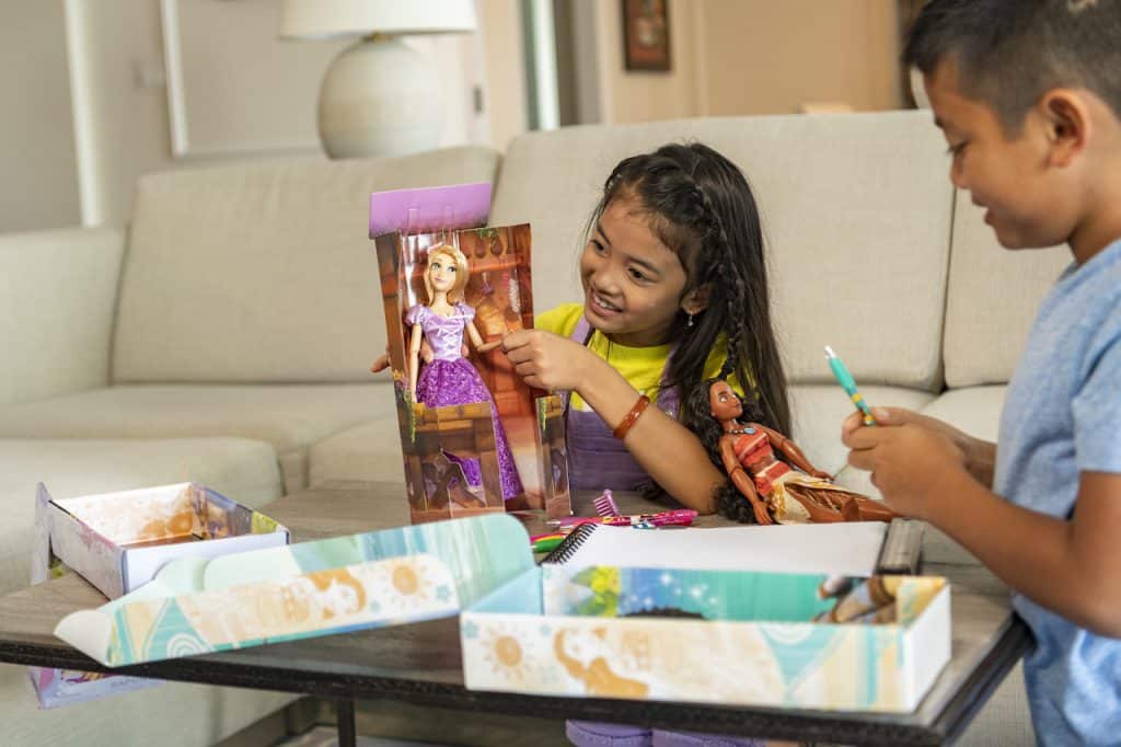 Girl playing with shopDisney doll