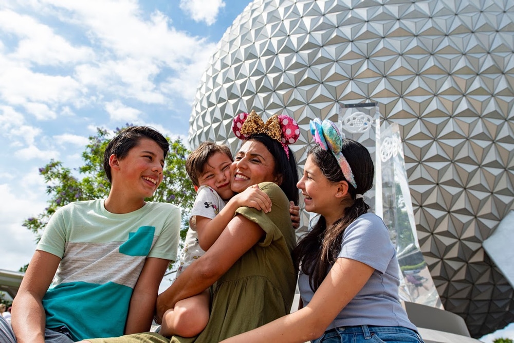 Family sitting in front of spaceship at EPCOT