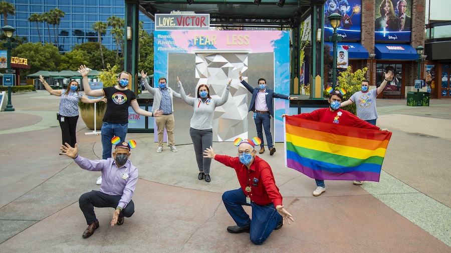 Members of the Disney PRIDE group posing in front of the "Love, Victor" photo activation in the Downtown Disney District