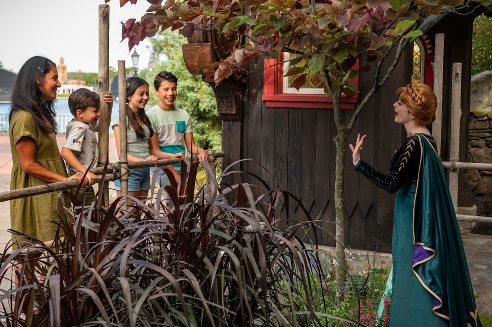 Family interacting with Anna at Frozen Ever After