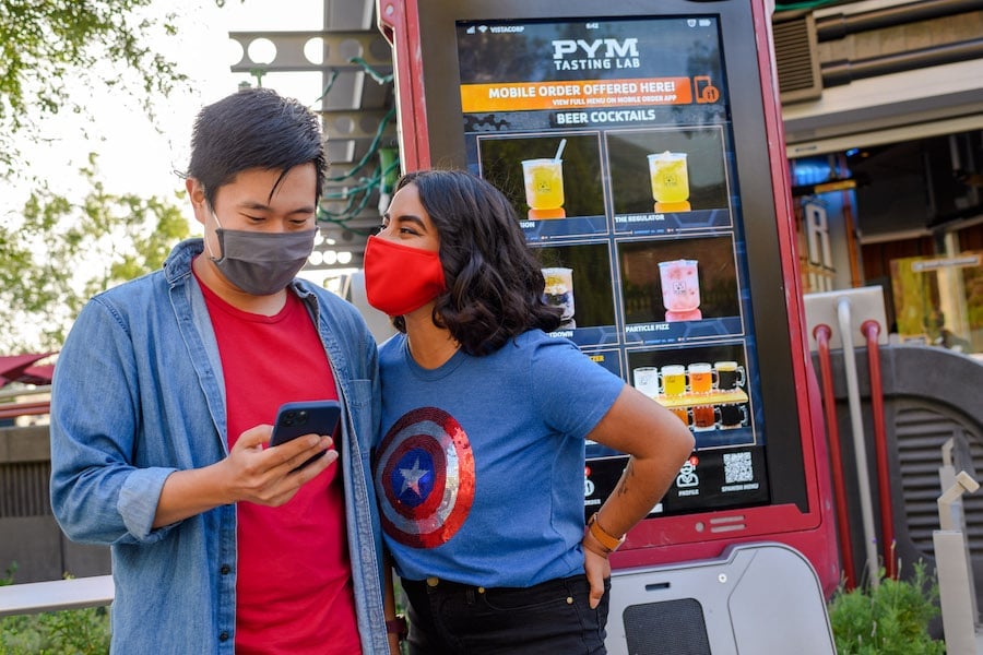 Couple using Mobile Order at Avengers Campus at Disney California Adventure park