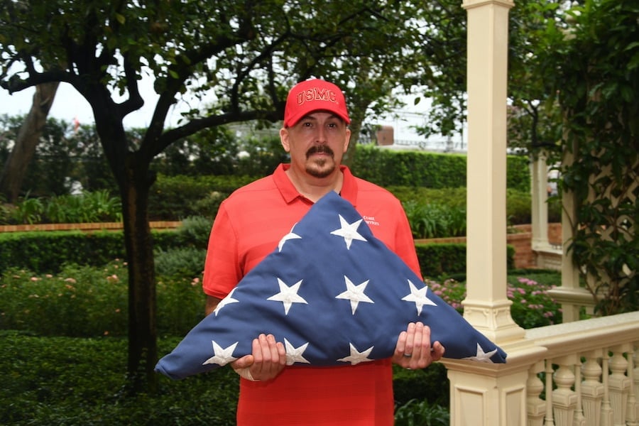 Rob Vickers of Gulf Breeze, Florida, with the flag at Magic Kingdom Park