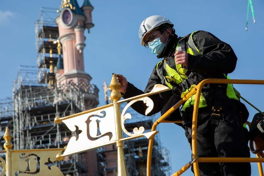 Cast member working on Sleeping Beauty Castle at Disneyland Paris