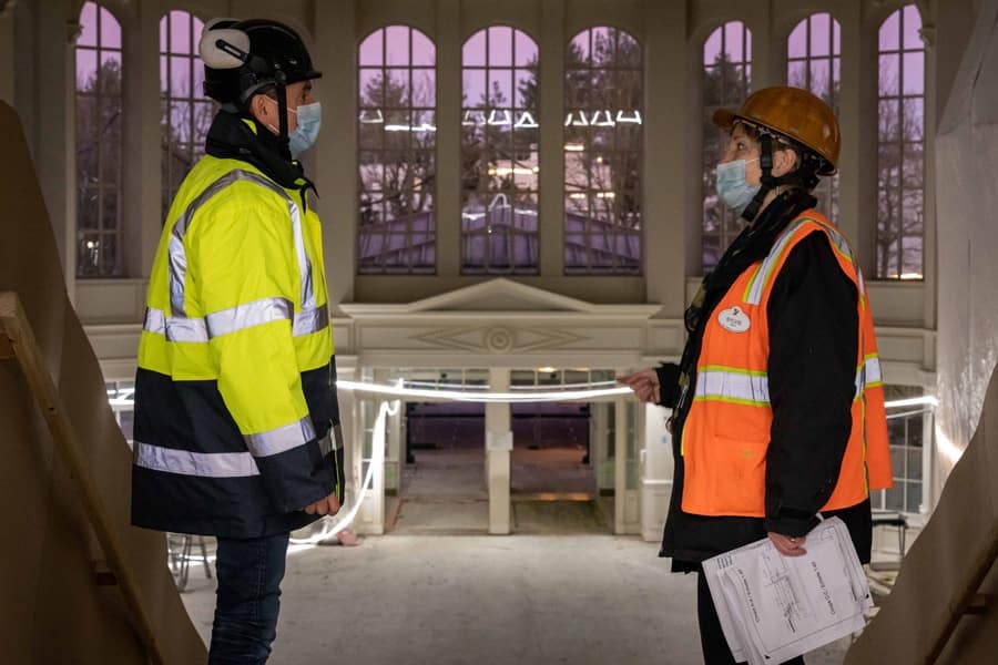 Imagineers inside hotel lobby standing on the stairs