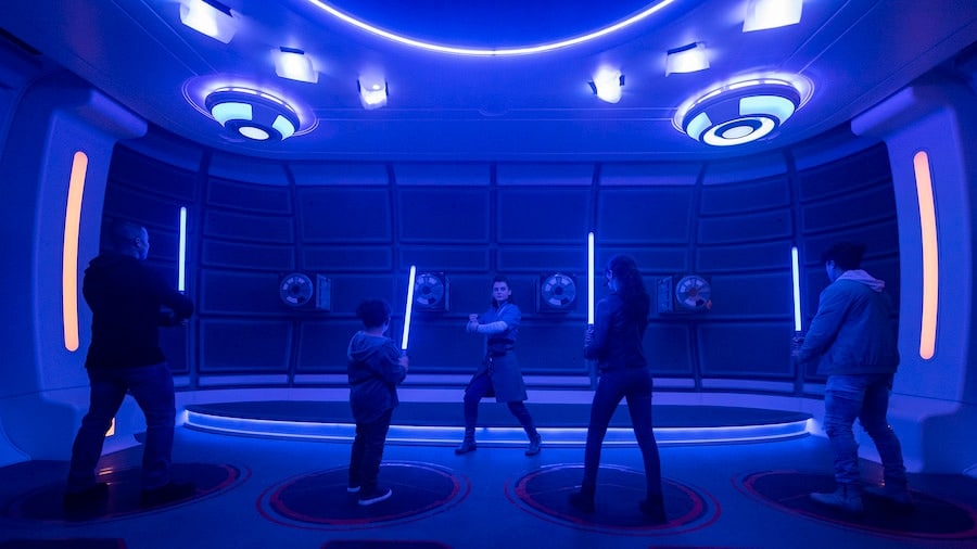 Passengers learn the ancient art of wielding a lightsaber in the Lightsaber Training Pod onboard the Halcyon starcruiser in Star Wars Galactic Starcruiser