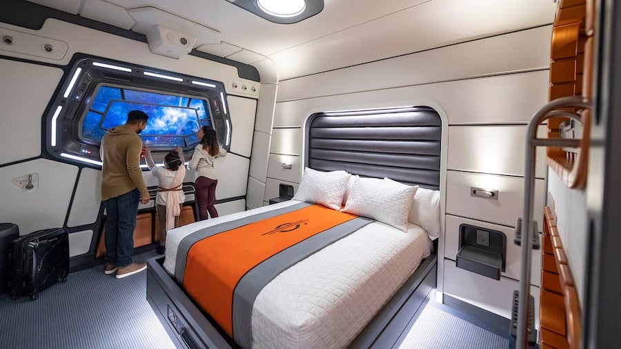 Passengers enjoy viewport to space in their Halcyon starcruiser cabin in Star Wars Galactic Starcruiser
