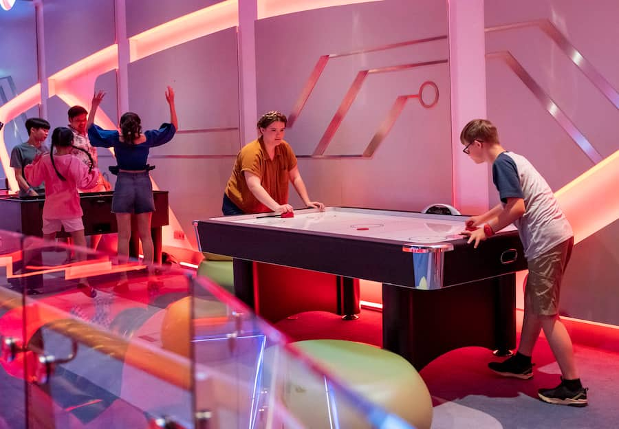 Family playing air hockey in Hero Zone