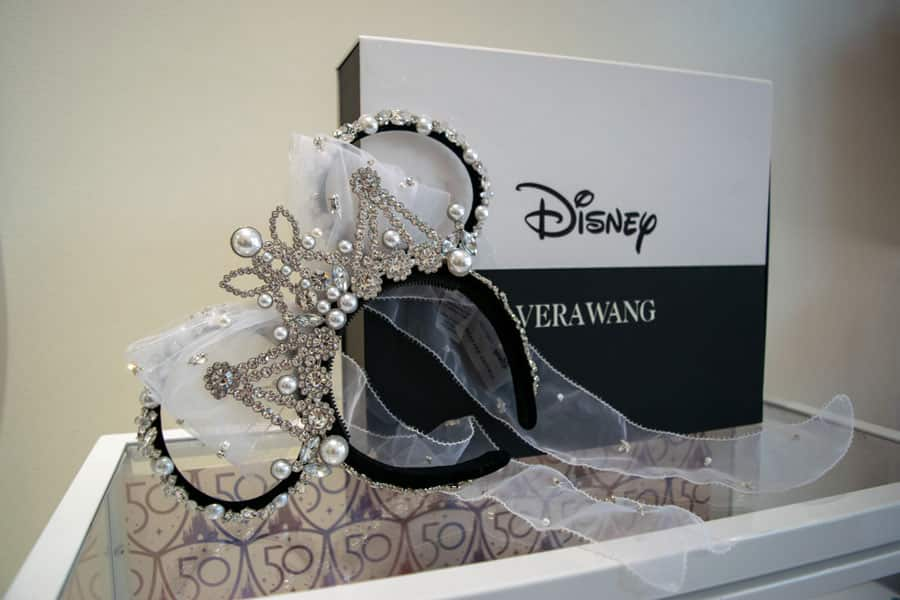 Vera Wang Minnie Mouse ear headband in front of the box it comes in.