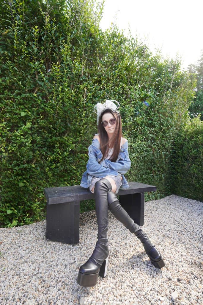 Woman sitting down posing with the Vera Wang Minnie Mouse Ear Headband