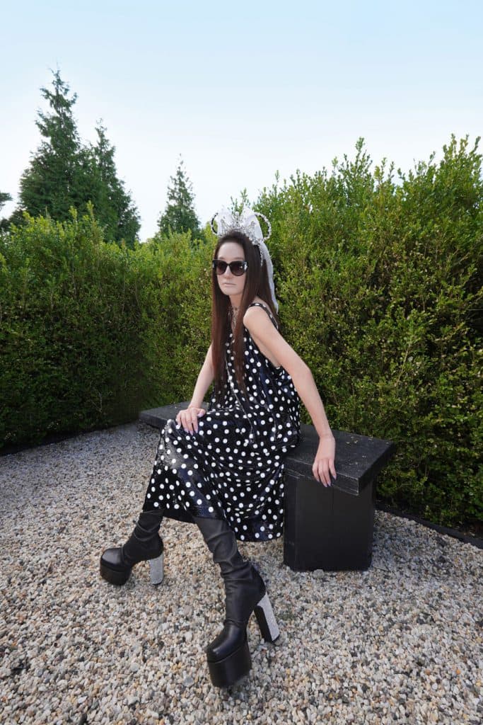 Woman sitting down posing with the Vera Wang Minnie Mouse Ear Headband