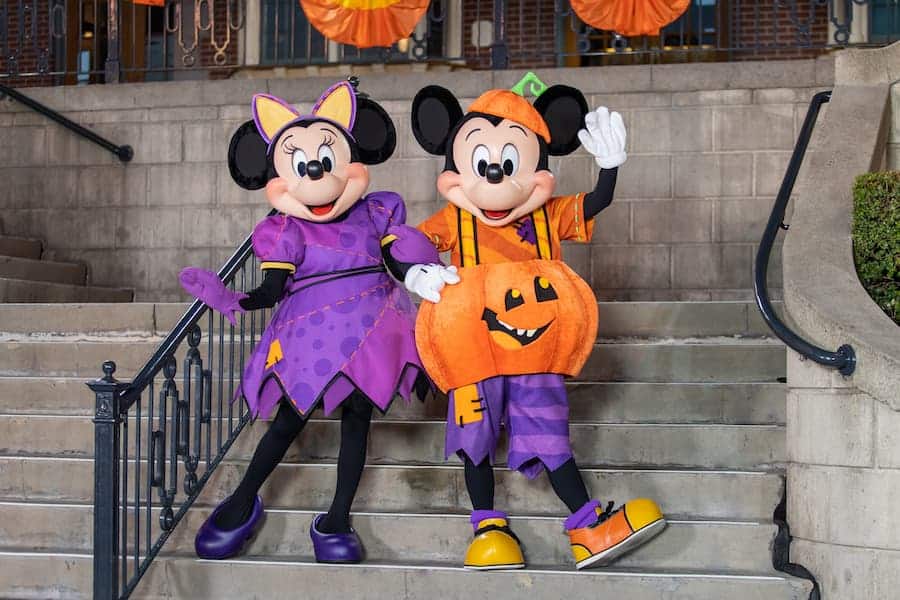 Mickey Mouse as a jaunty jack-o-lantern, Minnie Mouse as a stylish witch