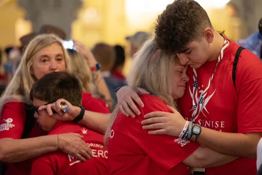 Loved ones hugging in Magic Kingdom Park