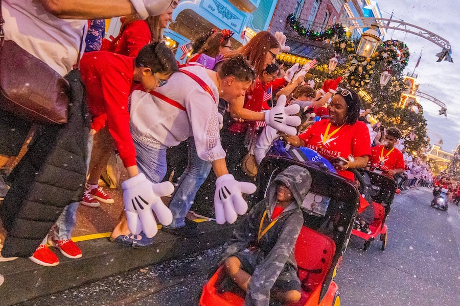 Families and Disney VoluntEARS along Main Street USA
