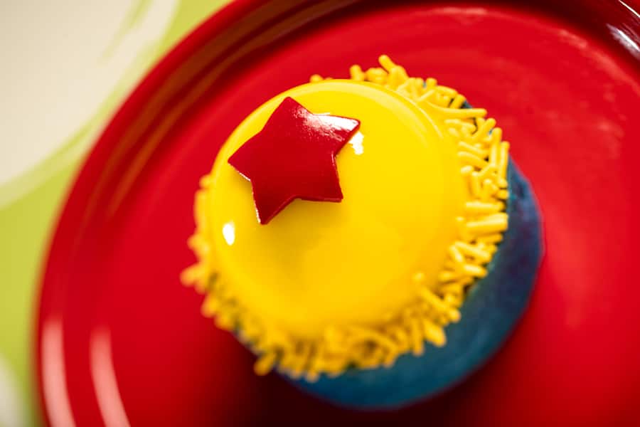 Playful Pixar Ball which is a dessert with baked vanilla cheesecake blueberry filling and lemon almond cake
