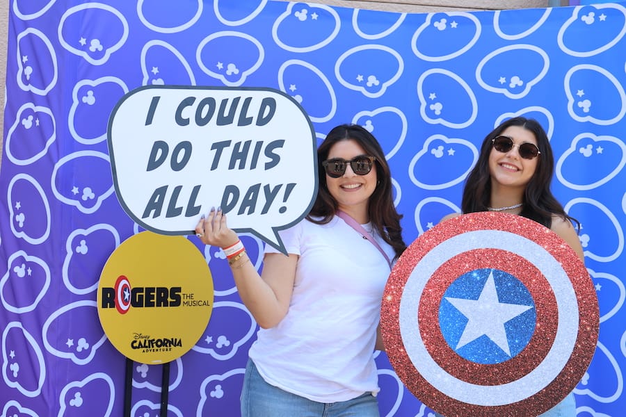 Cast members pose with 'Rogers: The Musical' themed props