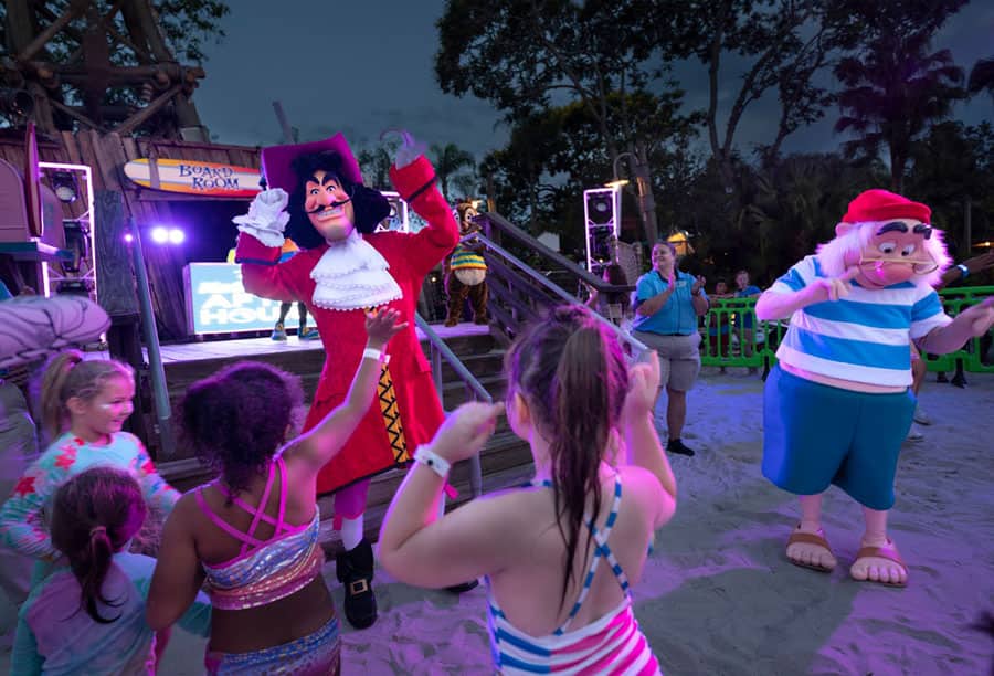 Captain Hook and Mr. Smee dancing with a group of children