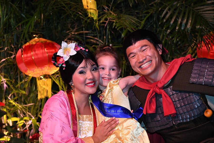 Young female wish child smiles with Mulan and Li Shang
