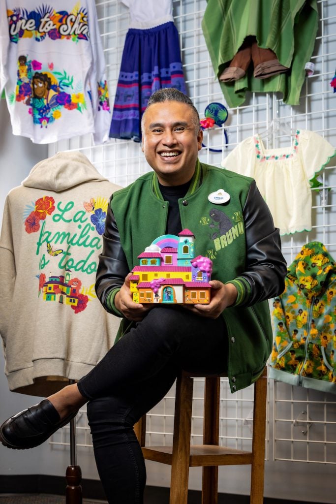 Emilio holding Casa Madrigal Light-up figure from the new Encanto La Familia Madrigal collection.