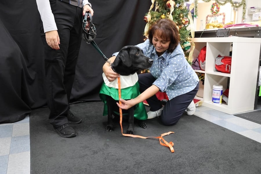 Cast member Mary Lou Cox measures Briar Rose for her choir robe