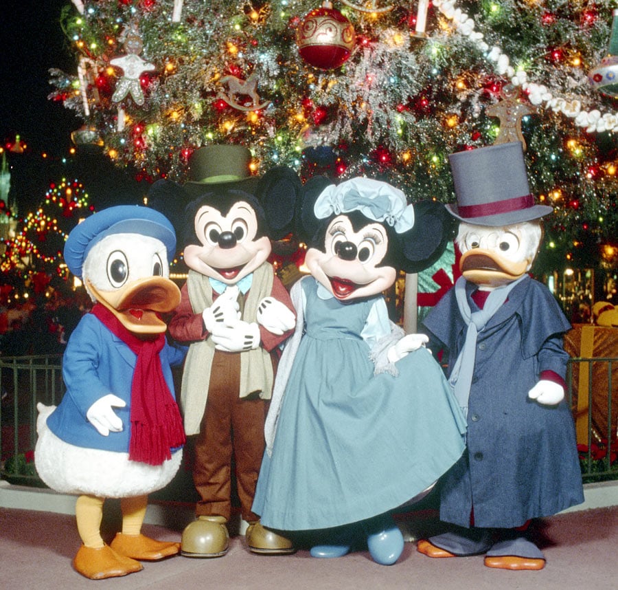Mickey Mouse Minnie Mouse Donald Duck and Scrooge McDuck dressed as Bob Cratchit Mrs Cratchit Nephew Fred and Ebenezer Scrooge in 1983 at Magic Kingdom