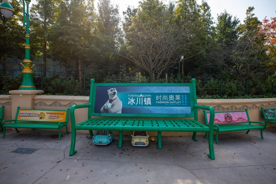 Photo of Zootopia at Shanghai Disney Resort featuring park elephant sized benches and hidden details of small cars parked underneath park benches