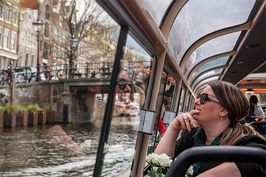 Guest on a river cruise looking out the window