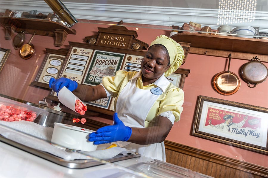 Cast member making Strawberry Crunch flavored popcorn from Popcorn Junkie available at Magic Kingdom Park