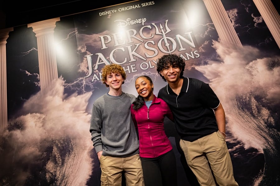 Image of Percy Jackson and the Olympians cast Walker Scobell (Percy), Leah Jeffries (Annabeth) and Aryan Simhadri (Grover Underwood) in front of new exhibit at Disney's Hollywood Studios at Walt Disney World.