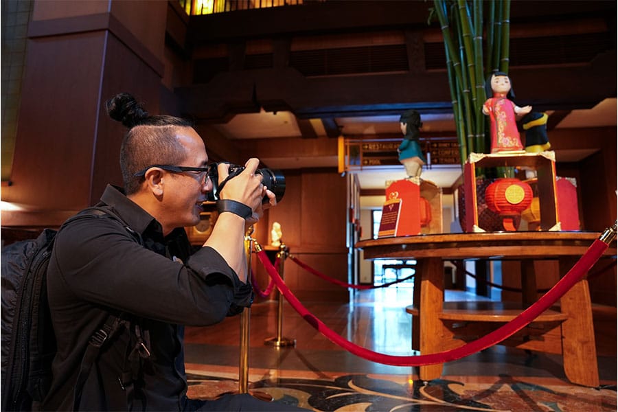 Disney cast member David photographing Lunar New Year displays at the Disneyland Resort
