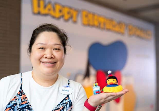| The Main Street Mouse a Hong Kong Disneyland Cast Member Poses with Her Duck