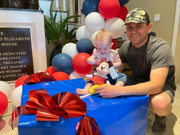 A veteran family staying at the Fisher House Sacramento enjoying some of the Disney product inside the special care packages
