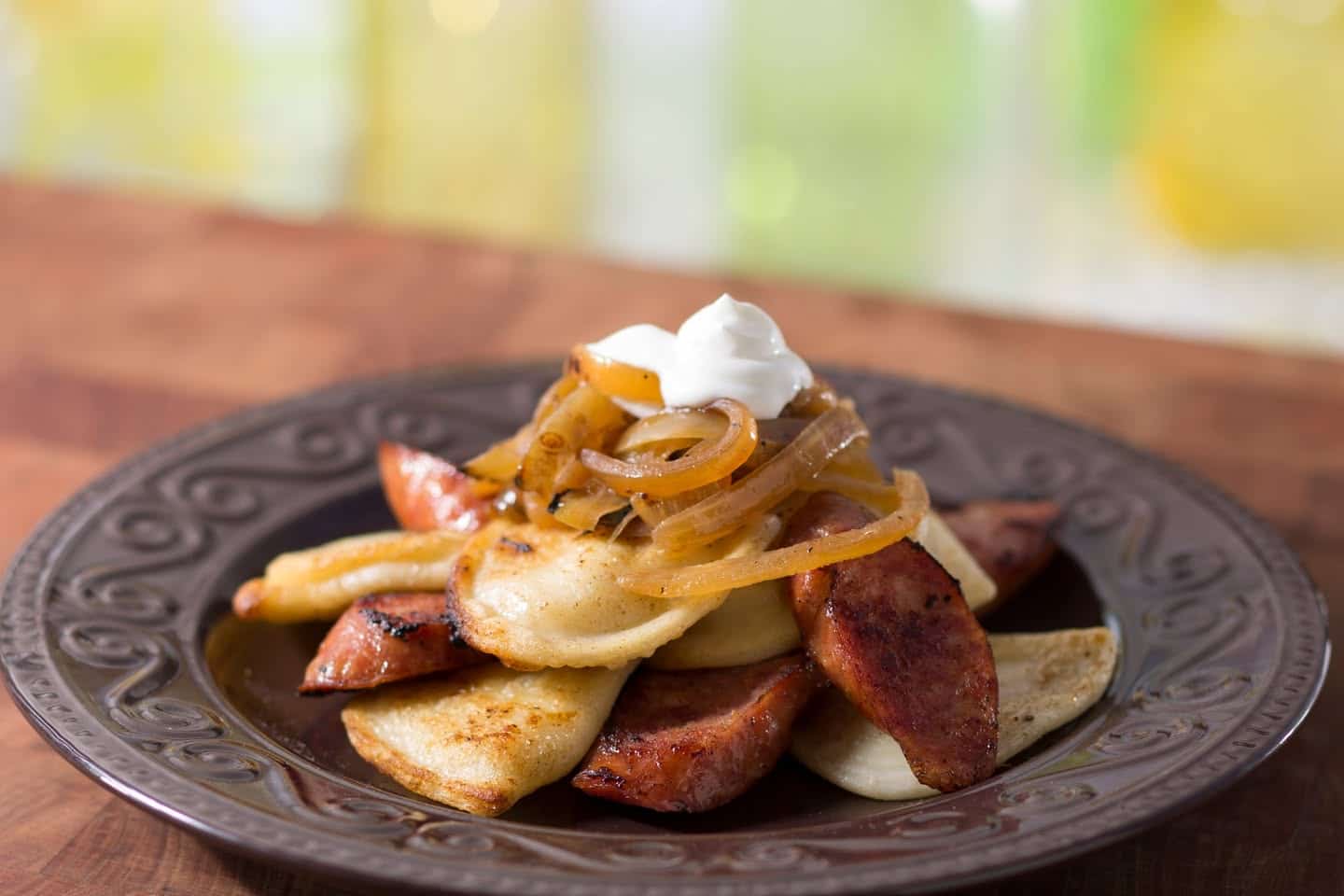 Potato Pierogi with kielbasa caramelized onions and sour cream
