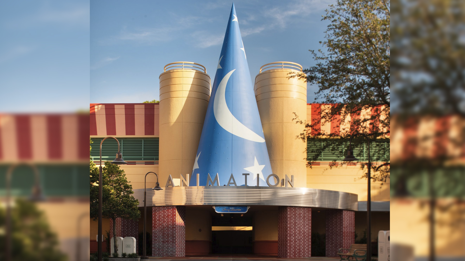 Disney Reveals New Magic of Disney Animation Experience | The Main Street Mouse Exterior View of a Themed Building with a Tall Blue Cone Sculpture Featuring White Stars and the Word animation on the Entrance Sign